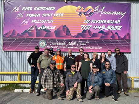 Photo of Six Rivers Staff in front of sign