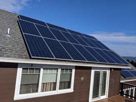 brown house with solar panels on roof