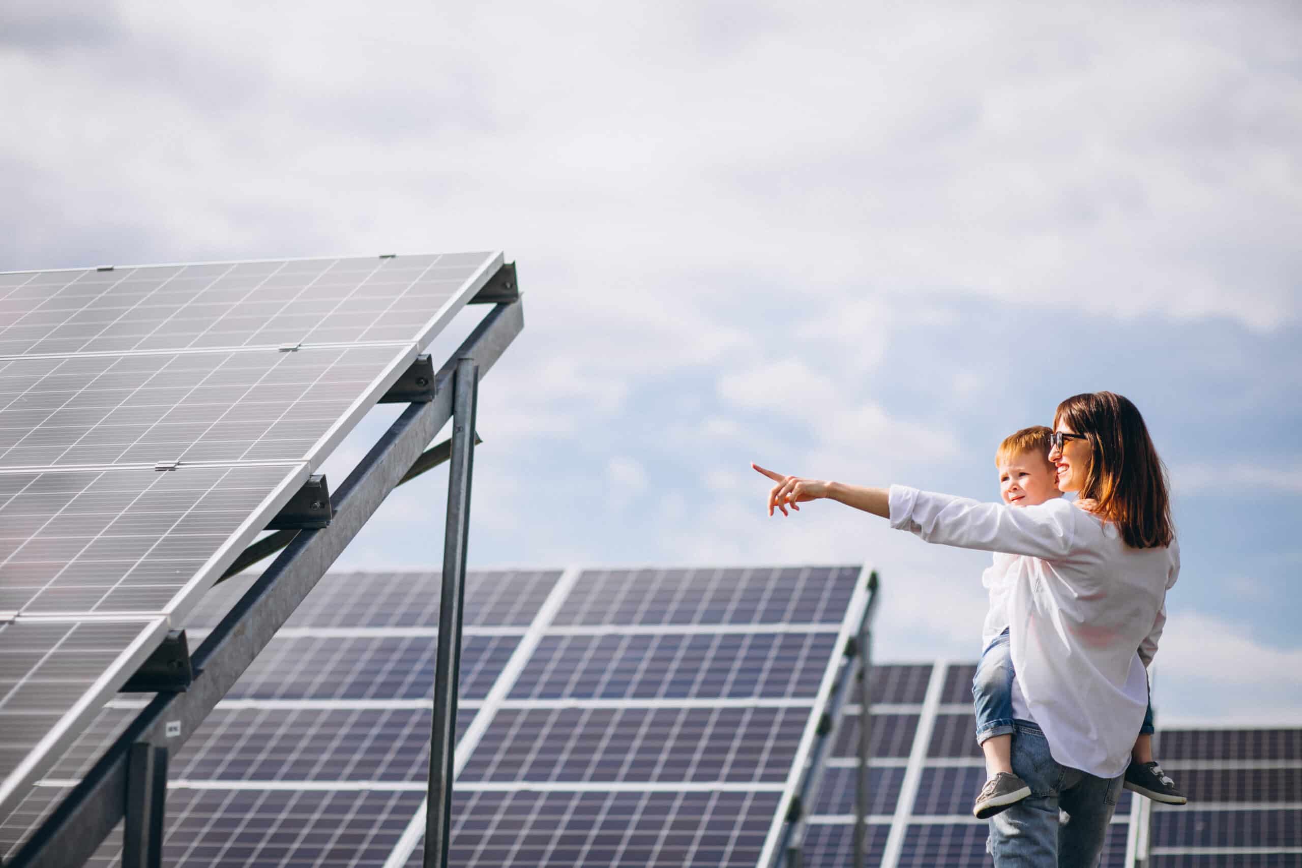 woman and child looking at solar panels