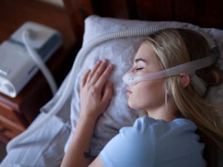 young person, sleeping with cpap machine.