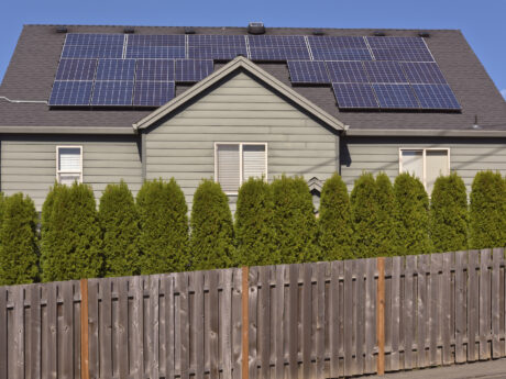 solar panels facing the sun on a roof of a house.